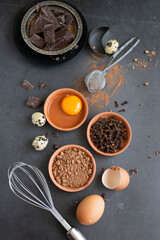 Mix of baking dessert ingredients on dark background, culinary flat lay