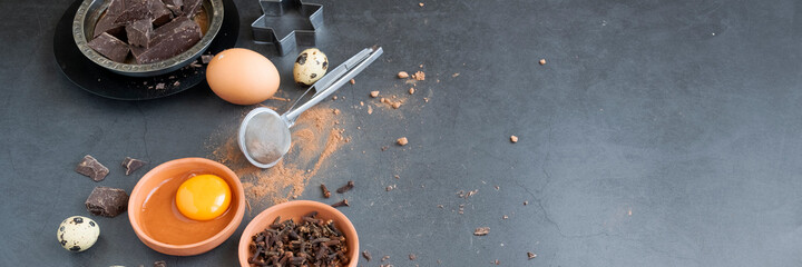 Mix of baking dessert ingredients on dark background, culinary flat lay