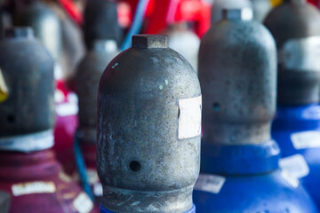 The upper part of gas cylinders with oxygen and acetylene with caps put on them.