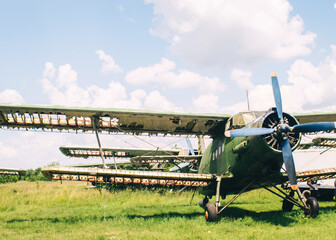 A close-up of an old wrecked passenger plane that has been decommissioned and stands for tourists. The fuselage shows traces of rust and chips. Parts of the metal structure are visible on the wings