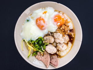 Close-up Pork Congee with Soft-boiled eggs is Asian breakfast. Food background