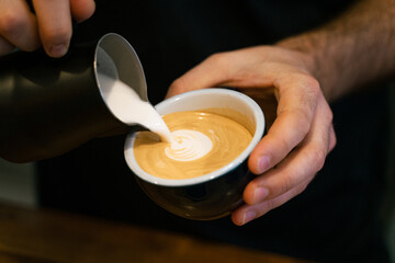 Fototapeta na wymiar Latte art poured by a barista