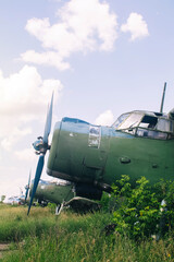 A close-up of an old aircraft engine showing rust and breakage. Visible radiator, blades, internal parts and traces of metal corrosion