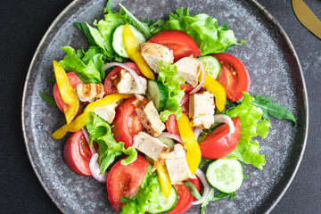 vegetable salad and chicken meat vegetables fresh tomato, cucumber, pepper organic dish on the table healthy food meal snack copy space food background rustic. top view