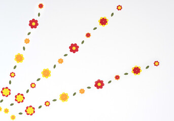 Bright red, yellow, orange paper flowers on white background. Spring, summer concept. Flat lay style with copy space