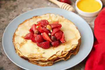 Pancakes, thin pancakes with fresh strawberries. On an empty background. Copy space.