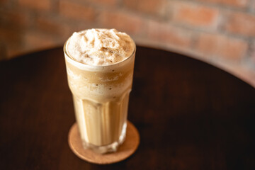 Milk tea. Beverage for summer with brick wall background.