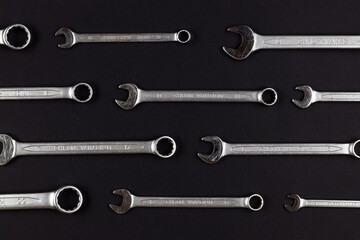 Wrenches, chrom vanadium spanners on black, dark gray paper background, steel hand work tools