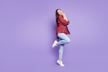 Fototapeta na wymiar Full length photo of sweet brunette hairdo young lady hold hands wear red shirt jeans isolated on purple color background