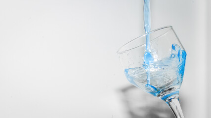 blue drink being put in the cup