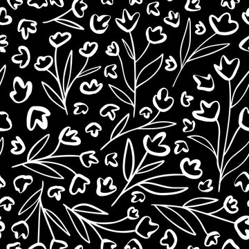 Doodled black and white flowers with leaves seamless repeat pattern. Random placed outline, abstract botanical elements all over surface print background.