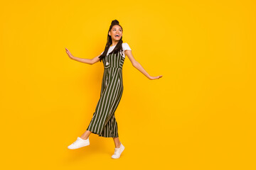 Full length profile side photo of young afro girl happy positive smile go walk step isolated over yellow color background