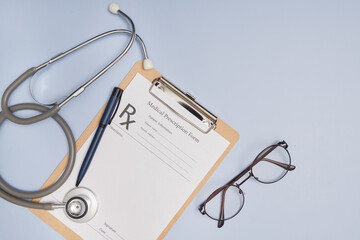 Stethoscope, a pen and a blank prescription pad.  Medicine or pharmacy concept. Empty medical form ready to be used. Modern medical Information technology. © sutlafk