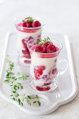 Healthy breakfast: yogurt parfait with fresh raspberries	