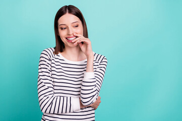 Photo of cheerful flirty lady hand chin look empty space wear striped shirt isolated on turquoise color background