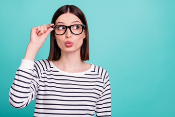 Photo of curious lady blow air kiss look empty space wear specs striped shirt isolated on turquoise color background