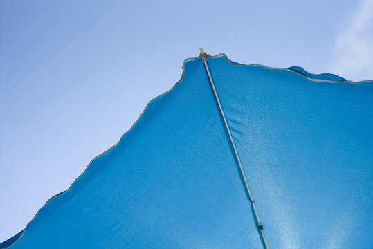 Blue Beach Unbrella On The Sky Background.