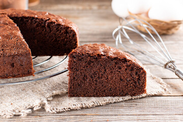 Photo of delicious chocolate sponge cake on table
