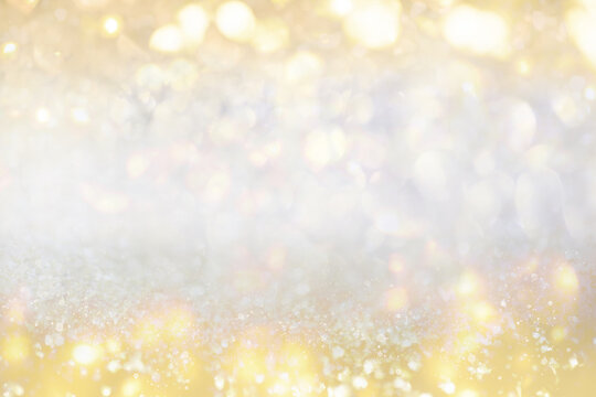 Gold light Festive Christmas background. Abstract twinkled bright background with bokeh defocused golden lights