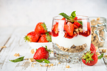 Parfait dessert. Yogurt with fresh strawberry and granola.