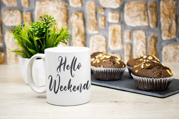 chocolate nuts muffins on blackboard plate with hello weekend concept on coffee cup