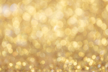Gold light Festive Christmas background. Abstract twinkled bright background with bokeh defocused golden lights
