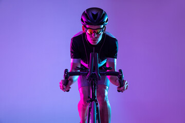 Cyclist riding a bicycle isolated against neon background