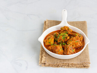 Spicy Chicken Curry in a White Pant on White Background