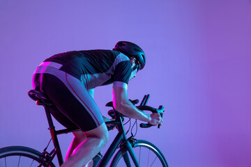 Cyclist riding a bicycle isolated against neon background