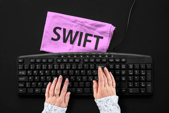 Swift programming language. Rag width word Swift and hands on pc keyboard
