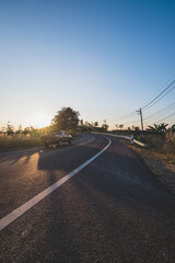 Evening sunlight and grass flowers along the road on the Nan Mountain . Nan Province, Thailand