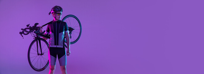 Cyclist riding a bicycle isolated against neon background