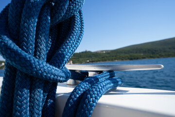 Blue double braided rope on a stainless cleat 