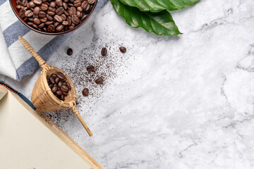 Female hand holding a coffee cup on the white kitchen table. Coffee cup americano coffee for breakfast. Top view, copy space, Young woman with a cup of delicious hot coffee at the table