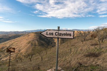 old wooden sign and iron pole