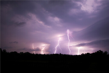 Fototapeta na wymiar Lightning streak from a thunderstorm cloud at night