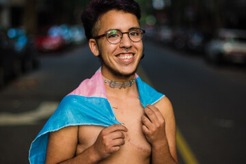Happy gen z trans boy with pink and blue flag