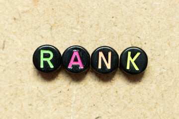 Black color round alphabet letter block in word rank on wood background