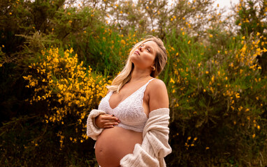 pregnant woman walking in the field and forest