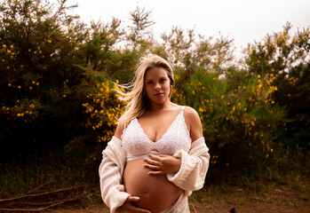 pregnant woman walking in the field and forest