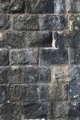 An old wall of concrete blocks with traces of time and destruction.Architectural texture.Close-up.Grunge background.Copy space.