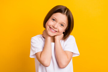Fototapeta premium Photo portrait small schoolgirl smiling cheerful cute lovely isolated bright yellow color background