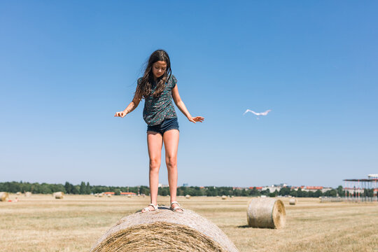 Girl Dancing On A Hay Bale