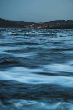 Dusk Landscape With Silky Water Waves And Mountains