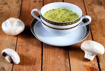 Vegetable soup on a plate on the wooden table
