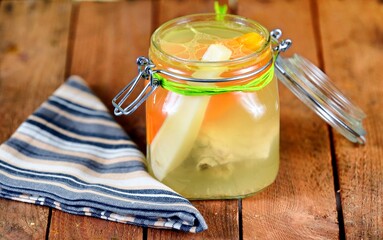Vegetable soup in the jar on the wooden table