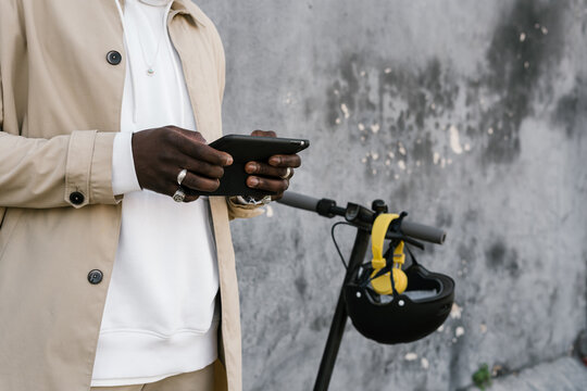 Black man using a mobile in the street