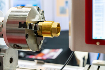 Copper pipe fitting or brass joint inside and outside thread setting on spindle chuck of automatic high precision cnc lathe turning machine