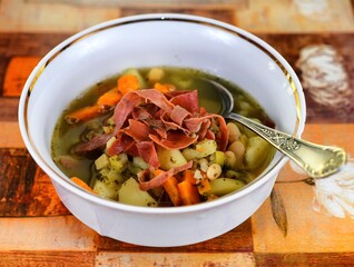 Vegetable soup on a plate on the wooden table