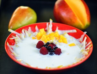 Milk soup on a plate on the wooden table